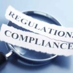 Regulatory Compliance CMMC MSP magnifying glass The words "Compliance" and "Regulations" are printed on a torn pieces of paper that sit on top of a magnifying glass which sits on a blue background. The image is created using a very shallow depth of field.